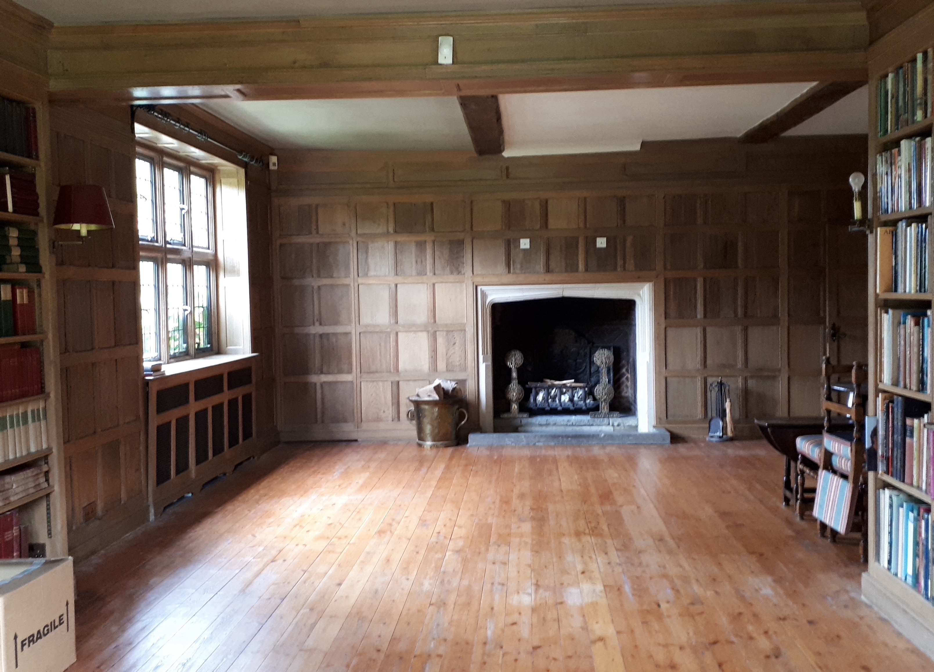 Oak panelling formerly in the library at Plumpton Place, as fitted to three walls in the room measuring, 585cm and two each of 440cm, individual sections of 192 x 72cm (the secret door); 258 x 110cm; 255 x 132cm; 260 x 1